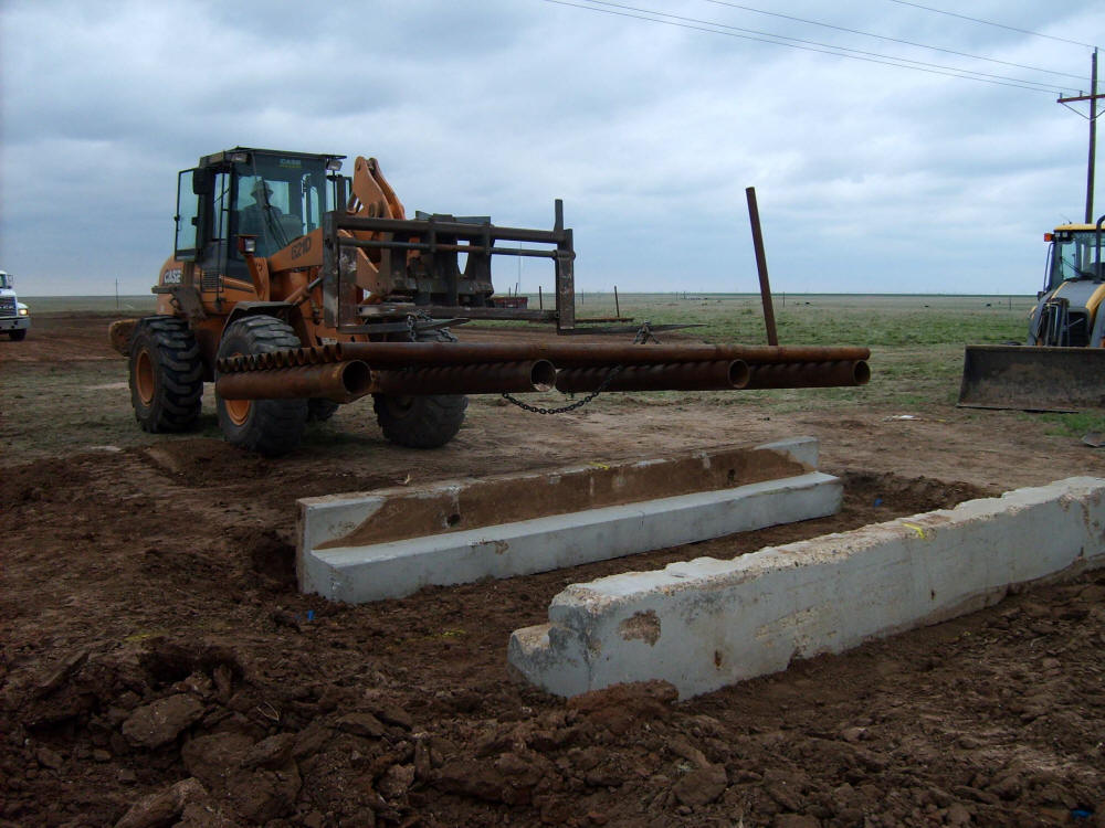 front loader installing grate for cattle guard